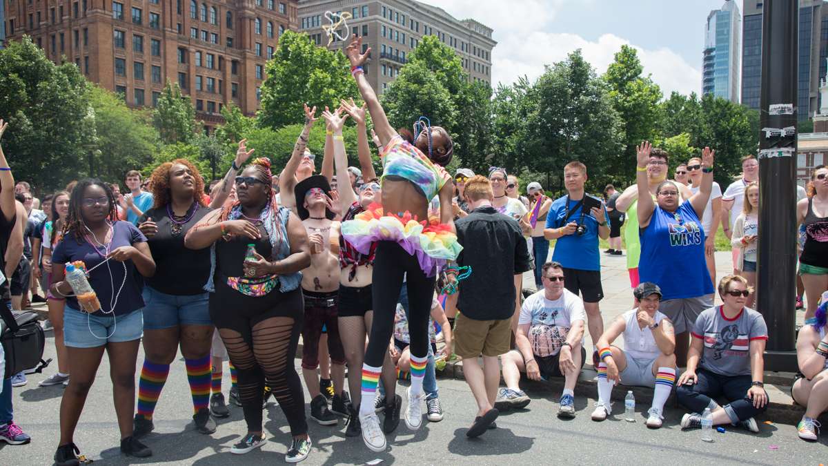Tiersa Curry, 19, jumps for beads at the 2017 Philadelphia Pride Parade, Sunday, June 18, 2017.