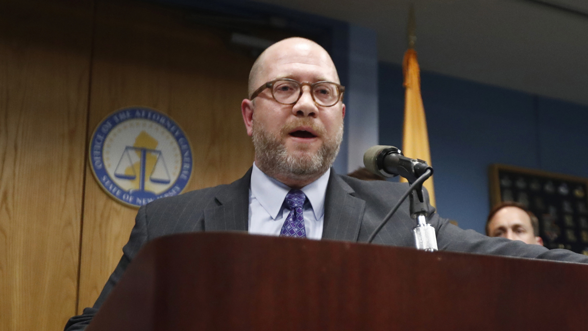 A bearded man at a podium