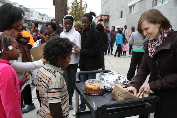 <p><p>Kristyn Stewart, director of PCAT, gives the winners of the "cake walk" game a free homemade cake. (Trenae V. McDuffie/for NewsWorks)</p></p>
