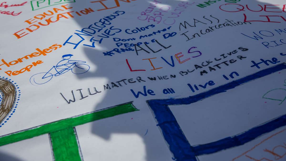 Kids from Neighborhood Bike Works covered a banner with issues that mattered to them. The banner will lead their delegation at the 17th annual Peoplehood parade in West Philadelphia, October 29th 2016.