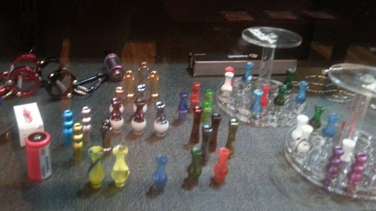 Vape accessories like drip tips, batteries and holders on display behind a galss counter at Love Vape (Photo courtesy of Love Vape)