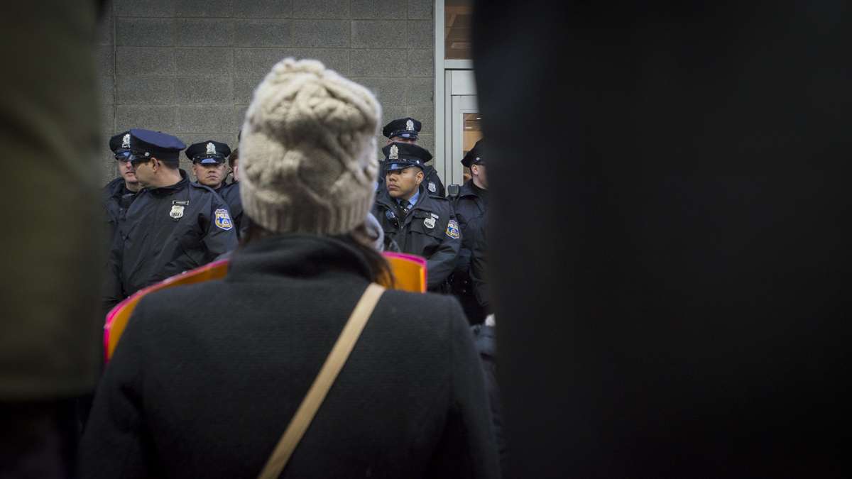 Police prevent protesters from entering the terminal at Philadelphia International Airport. (Branden Eastwood for NewsWorks)