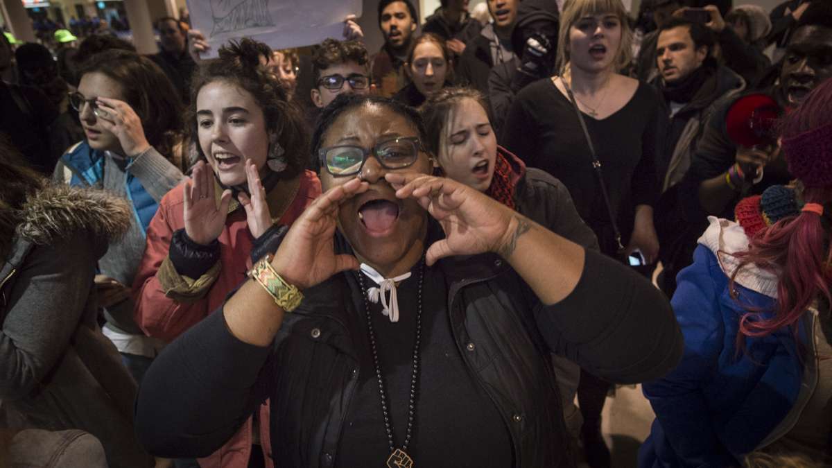 Protesters chant slogans inside the terminal at Philadelphia International Airport.