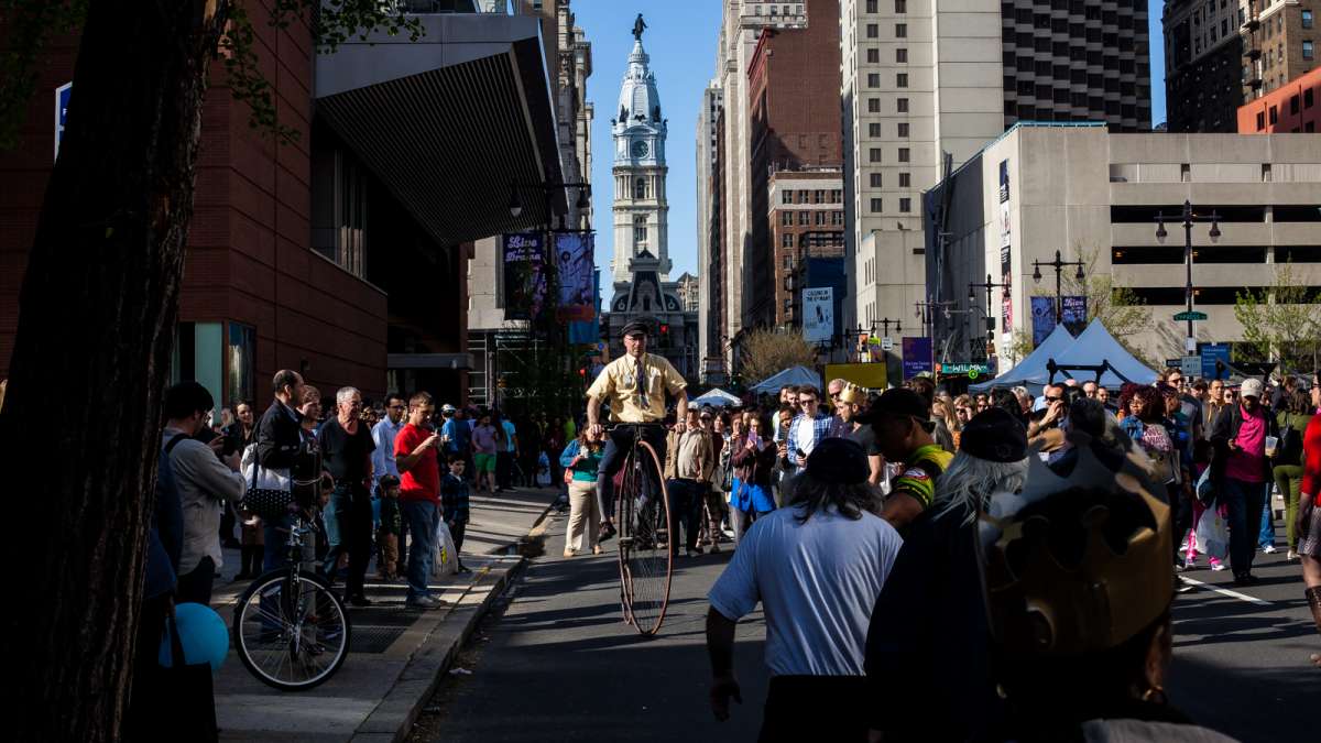 Eric Knight of The Wheelmen bicycle club rides his penny-farthing for curious spectators on South Broad Street.