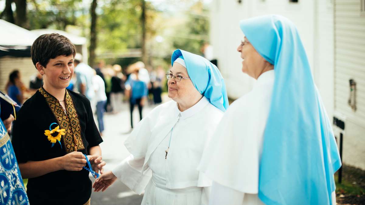 Sister Maria (middle) and Sister Timothea (right) talki to Michael Spotts (left) after Divine Liturgy.