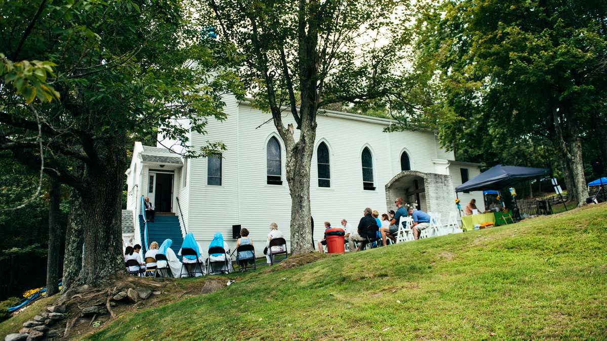 People gather outside Assumption B.V.M. on the lawn to listen to the Divine Liturgy at the Marian Pilgrimage.