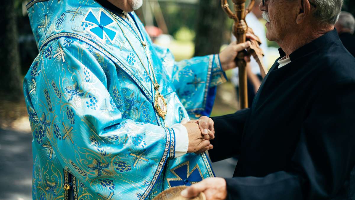 A man named Uriy (George) shakes hands with Metropolitan-Archbishop Stefan Soroka.