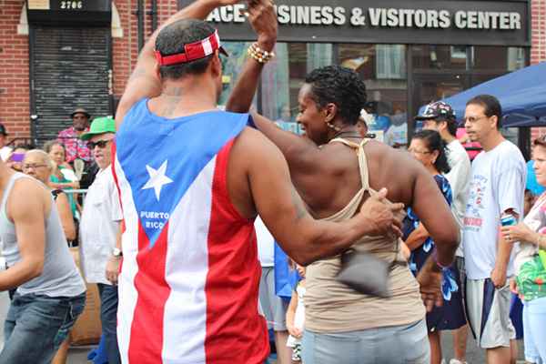 Festival goers dance to the rhythm of the Johnny Cruz Latin Ensemble at the 2013 Nuestro Barrio Fair.  (Elisabeth Perez-Luna/WHYY)