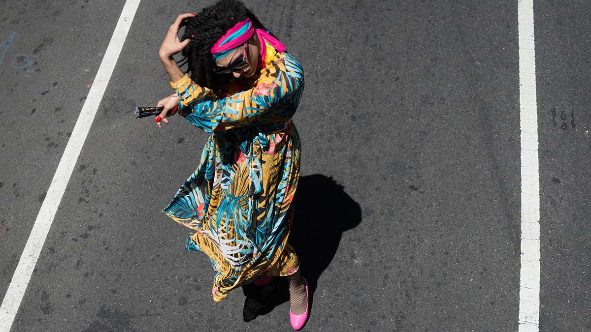 Maria TopCatt arranges her hair at Philadelphia Pride Parade and Festival. (Branden Eastwood for NewsWorks)
