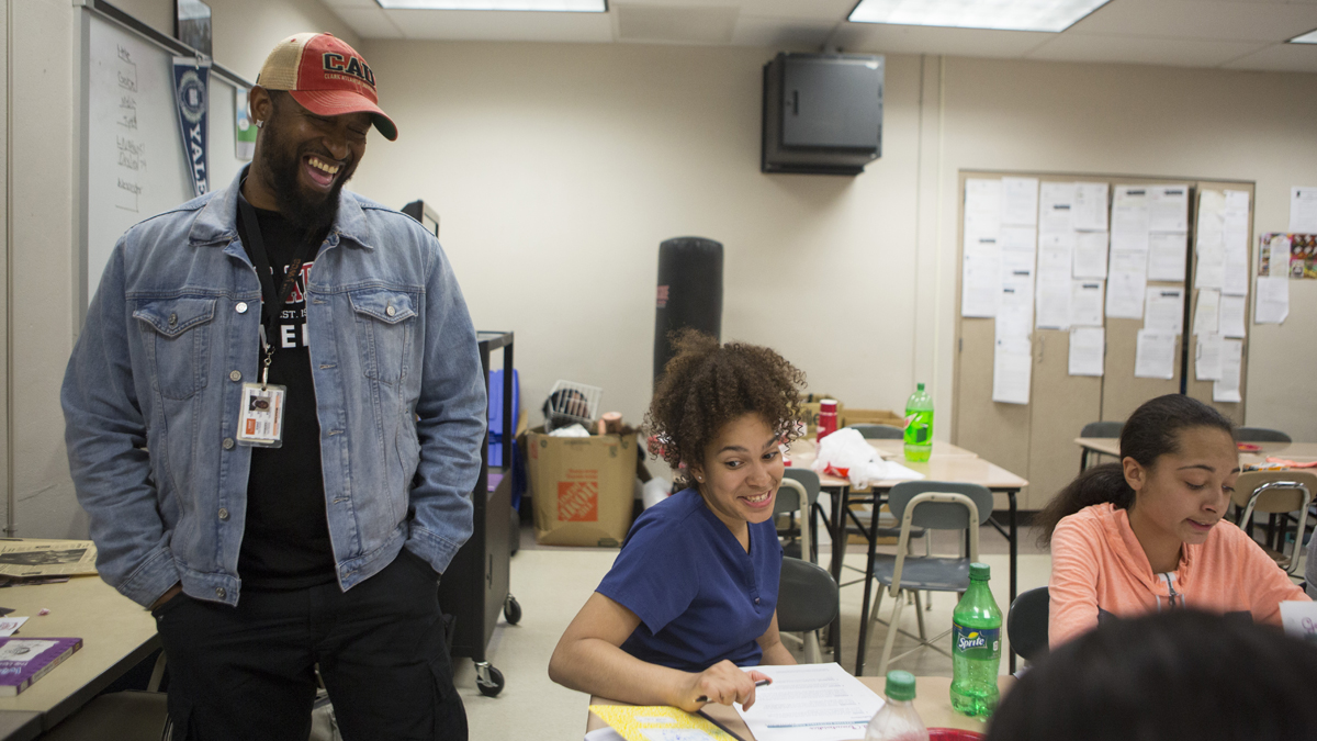  Mike Smith, left, grew up in York, and works with kids like Liz Herrera-Reynoso, 14, center, to deal with obstacles they face growing up here. As part of his job, Mike runs an after school college prep program, the York Temple Guard program and spends time counseling families on where to send their kids to high school. (Jessica Kourkounis/ For Keystone Crossroads) 
