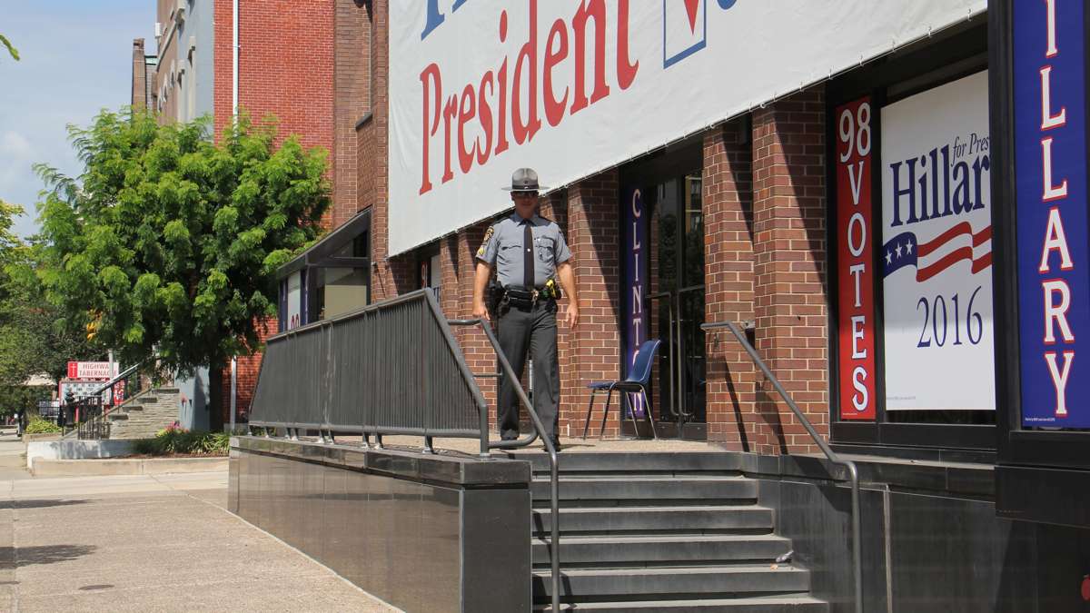 A state trooper stands guard in front of the Local 98 union hall on Spring Garden Street. (Emma Lee/WHYY)