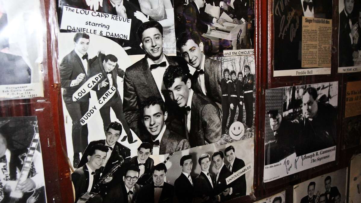 Owner Lou Capozzoli decorates the bar with images from his musical past. 'Never get old,' he says. (Kimberly Paynter/WHYY)