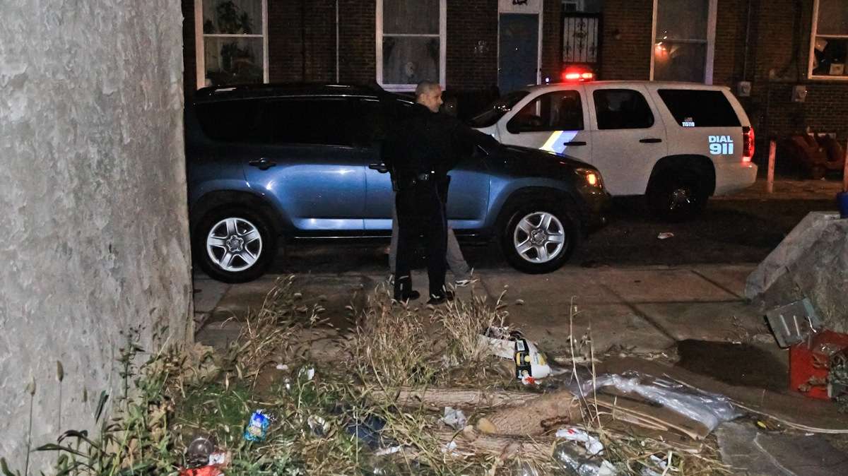 Officer Gerson 'Gus' Padilla searches a 14-year-old suspect on a the 2300 block of Franklin Street in South Philadelphia. (Kimberly Paynter/WHYY)