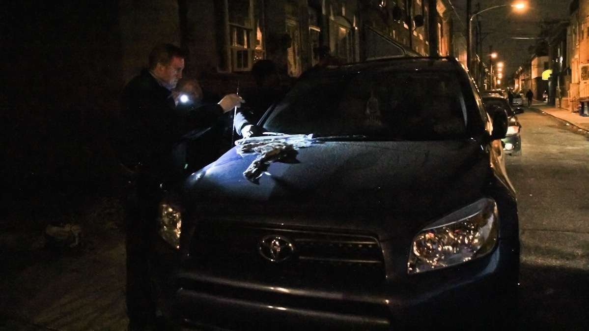 Officers Gerson 'Gus' Padilla and James O'Neill question a subject on Franklin Street in South Philadelphia. They confiscate a scarf and toy gun. (Kimberly Paynter/WHYY)