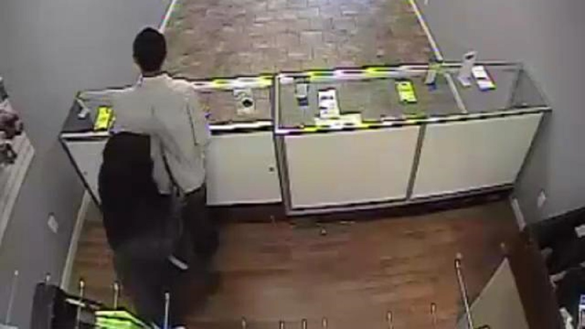  A surveillance camera captured the knifepoint robbery inside a cell-phone store near Germantown and Chelten avenues.(Courtesy of Philadelphia Police) 