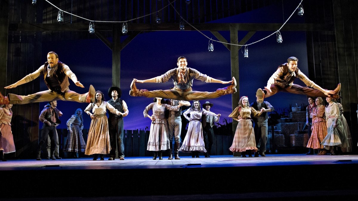  In front of the cast of 