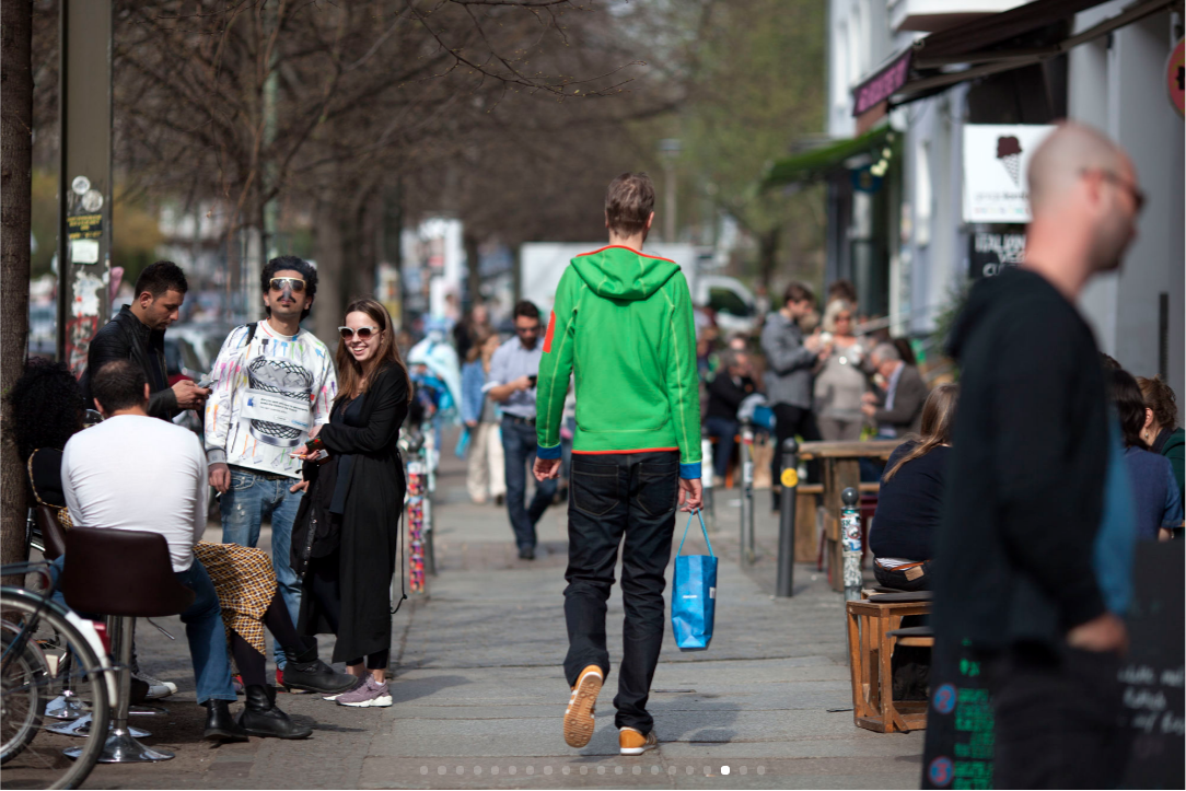 People shop and socialize along a popular strip of upscale shops and trendy restaurants in Old Mitte. (Jessica Kourkounis for Keystone Crossroads)