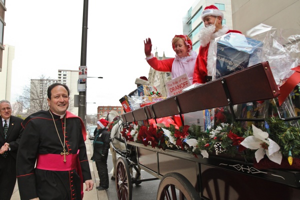 <p>Bishop McIntyre greets the Dranoff Santas after their ride through Center City. (Kimberly Paynter/WHYY)</p>
