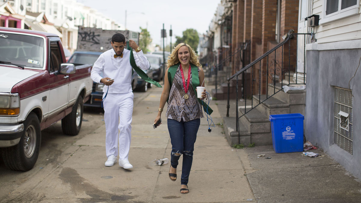  Walking down her block, Savannah beams with pride on graduation day. (Jessica Kourkounis/For Keystone Crossroads) 