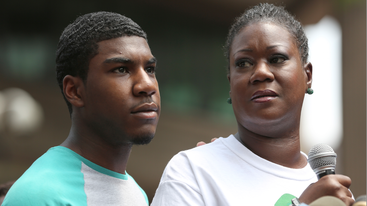  Sybrina Fulton, mother of Trayvon Martin, is joined by her son Jahvaris Fulton as she speaks to the crowd during 