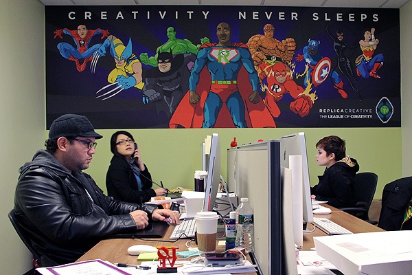 <p>Juan Nino, Erica Chan and Lauren Dove put in another busy day at Keith Leaphart's Replica print shop on 18th Street. (Emma Lee/for NewsWorks)</p>
