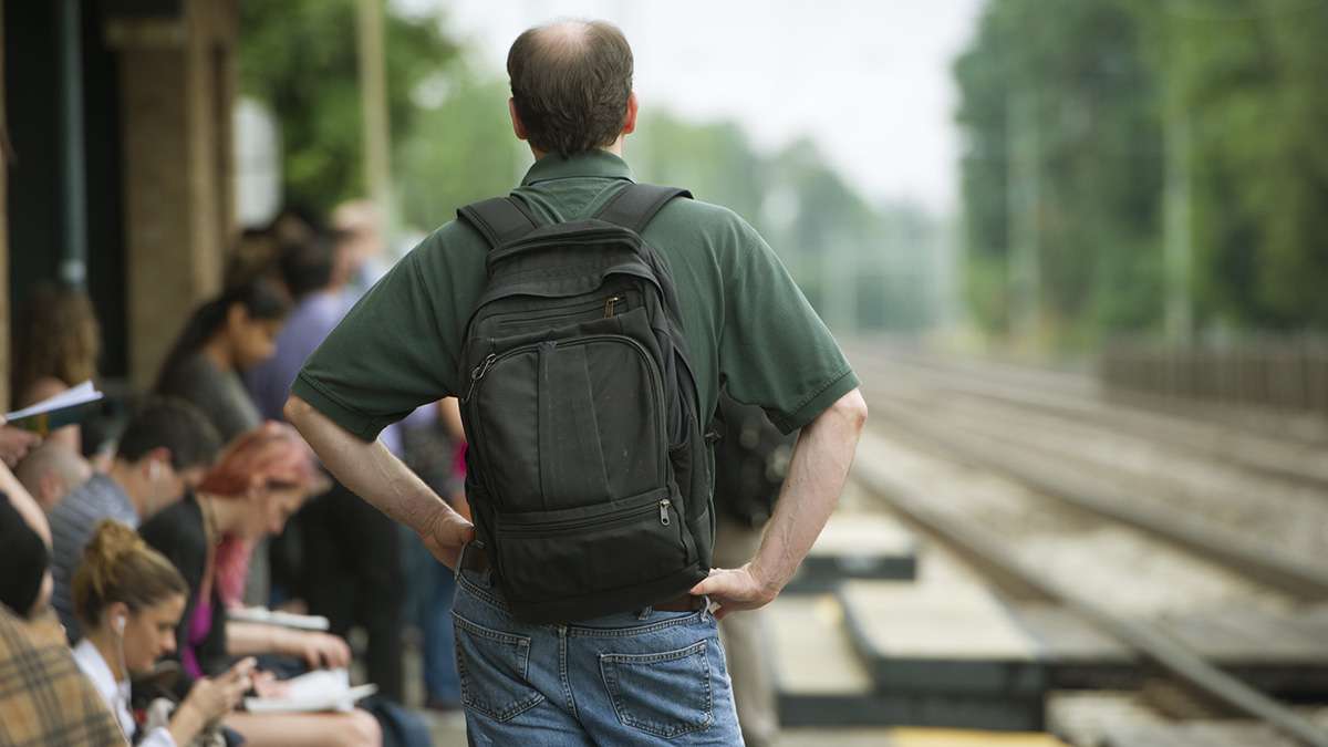 A passenger waits at the Ardmore Station for a train to Philadelphia. SEPTA trains are running on a modified Saturday schedule. (Jonathan Wilson for WHYY)