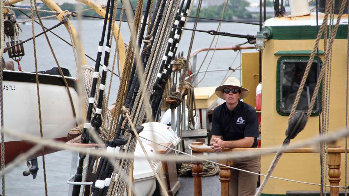 Capt. Sam Sikkema guides the Picton Castle as it cruises up the Delaware River. (Emma Lee/WHYY)
