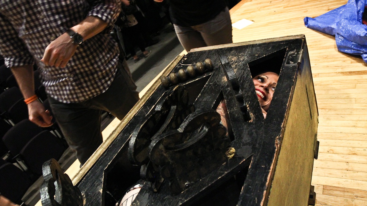  Reggie Bugmuncher of Olde City Sideshow contorts her body around blades in a box. (Kimberly Paynter/WHYY) 