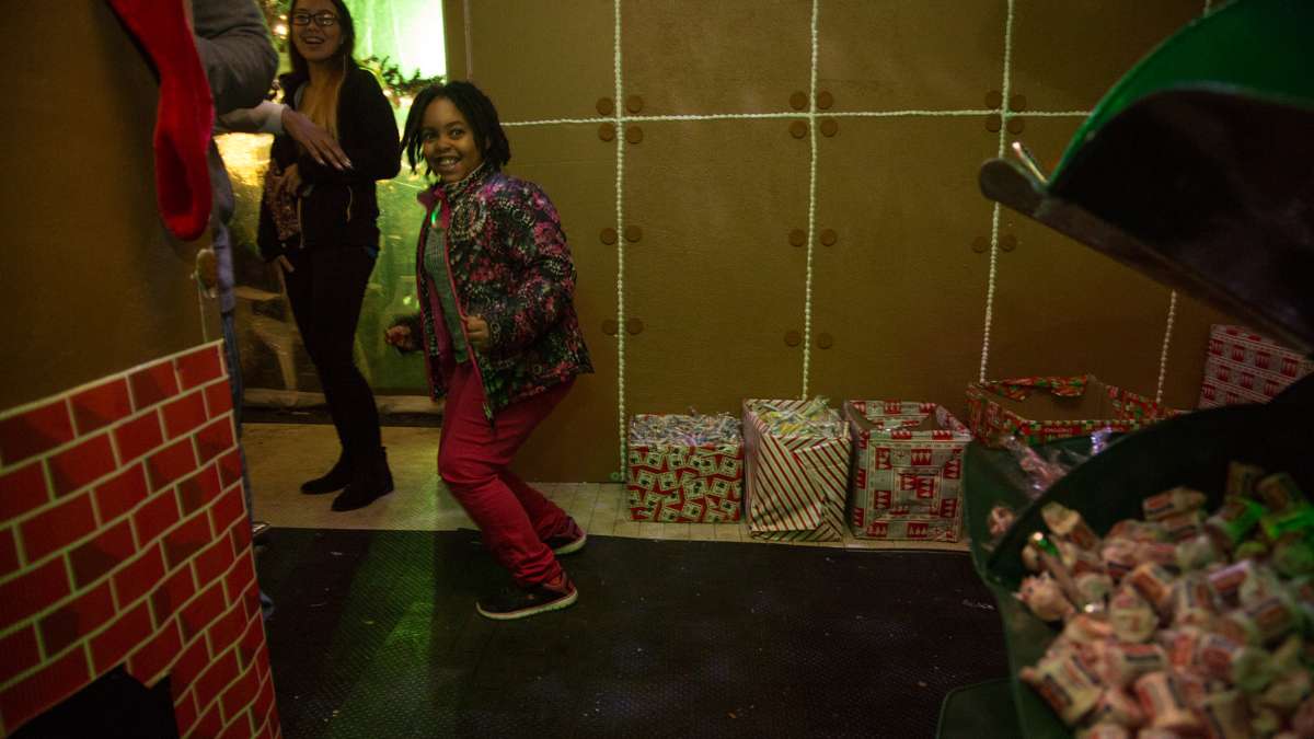 Eight-year-old Jael Barefield finds the gingerbread house inside Ben's Sweets and Treats, where kids can create their own candy bags.