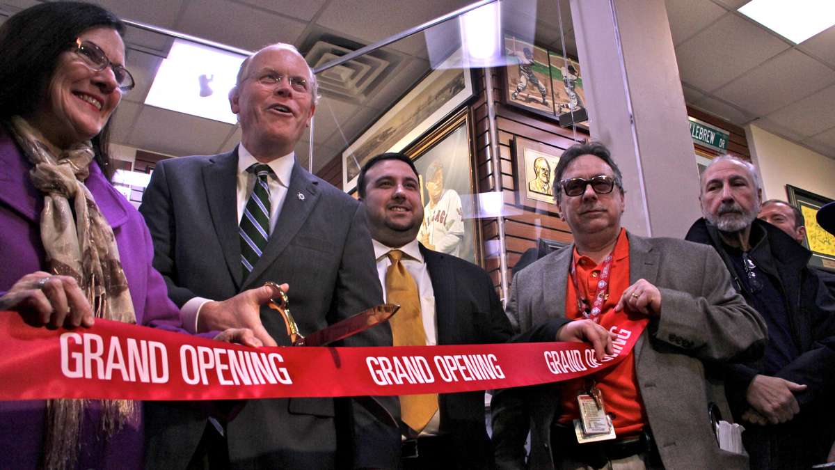 Former Collingswood Mayor Jim Maley cuts the ribbon held by members of the DePace family. (Emma Lee/WHYY)