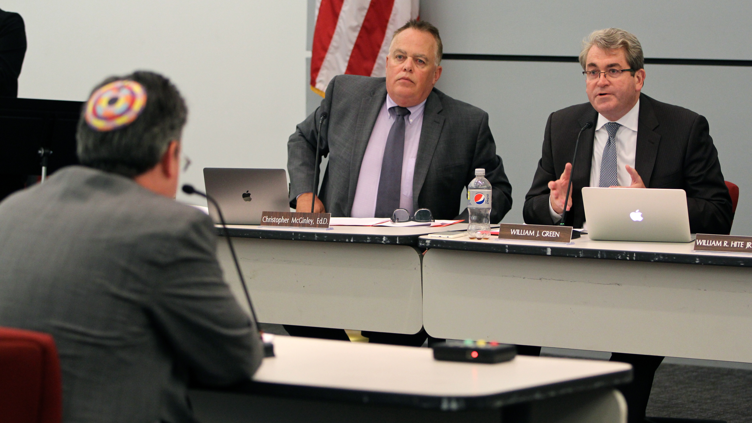  Philadelphia schools Chief Financial Officer Uri Monson (left) answers questions from School Reform Commission members about the district's new teachers contract. Commissioner Bill Green (right) cast the sole vote against the contract. (Emma Lee/WHYY) 