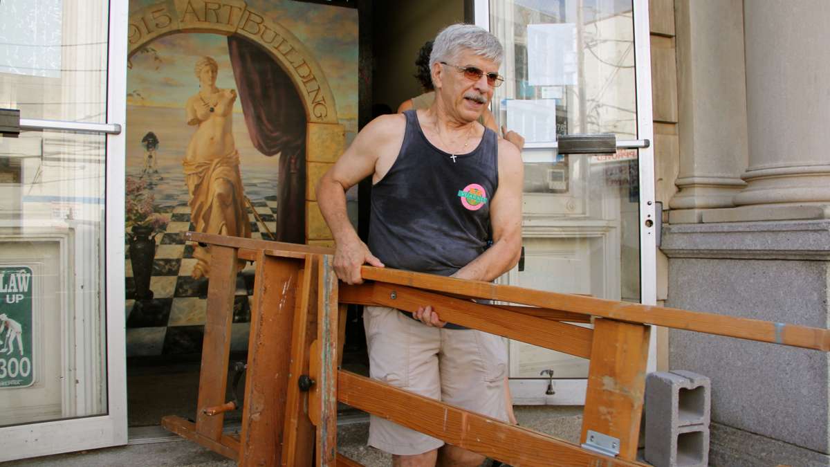 Giuseppe Riviera takes what he needs from his studio at 915 Art Building. The building, which provides studio space to 100 artists, was closed because of fire code violations. (Emma Lee/WHYY)