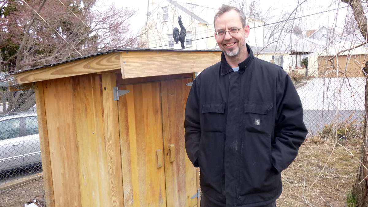 Thilo Marg-Bracken, father, and builder of the coop, made of an old dresser and recycled hardware. (Jennifer Lynn/WHYY)
