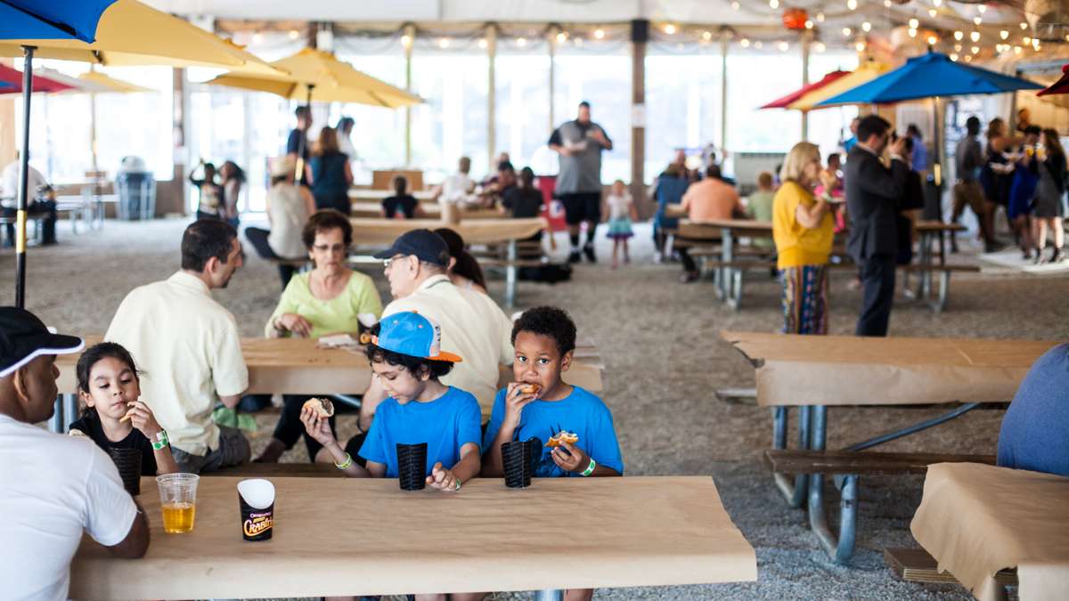 Visitors snackon cheesteaks, crab fries and seafood inside the lodge at the Penn's Landing River Rink.