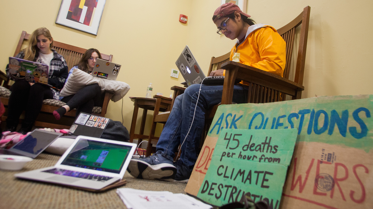 Swarthmore College students gather near the office of the president during day two of a sit-in to call for an end to the college's investment in fossil fuels. (Brad Larrison/WHYY)