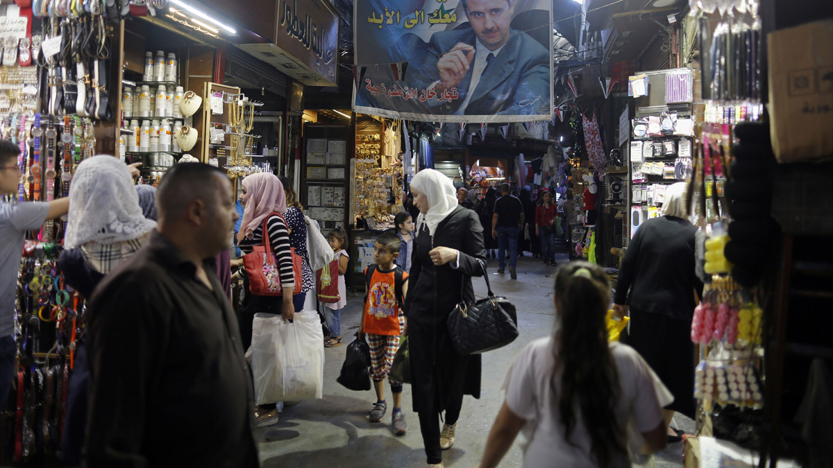  Syrians shop at the Hamadiyah market, or souk in Arabic, that was named after the 34th Sultan of the Ottoman Empire Abdul Hamid II, in the Old City of Damascus in May. (AP Photo/Hassan Ammar, file) 