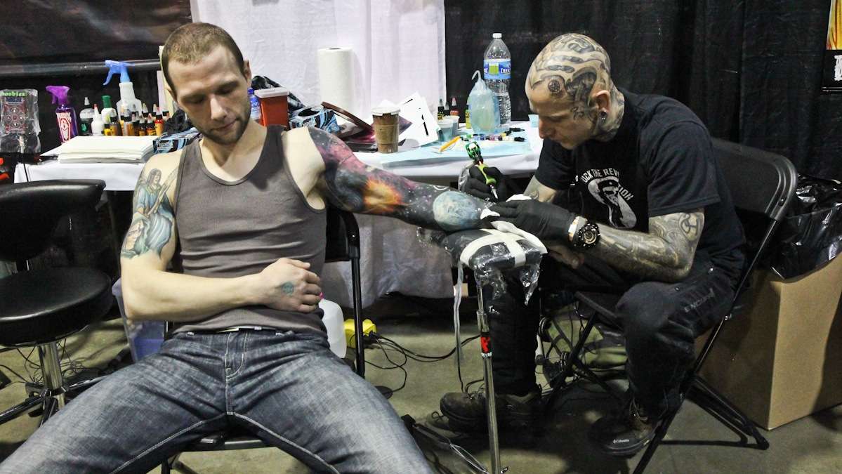  Jason Strapec has stars added to his space sleeve by Philadelphia artist Dan Henk. (Kimberly Paynter/WHYY) 