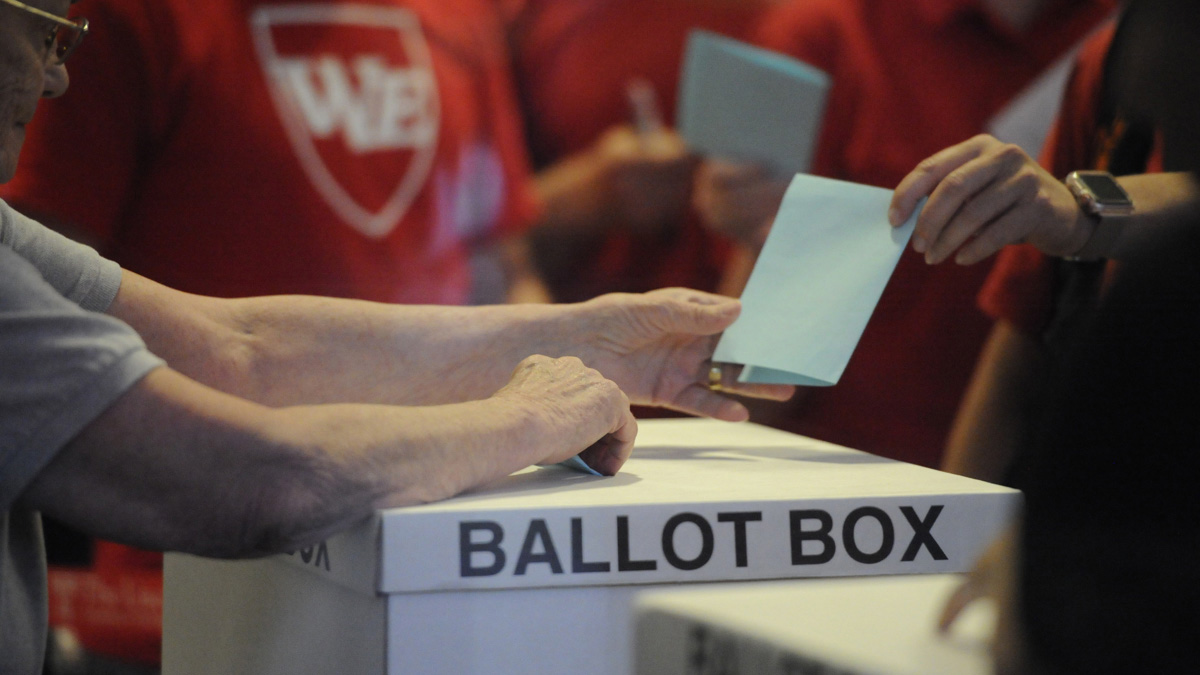  A member of the Philadelphia teachers union hands in a ballot in 2017 at Temple University's Liacouras Center as the Philadelphia Federation of Teachers voted on a contract proposal. (Jonathan Wilson for WHYY) 