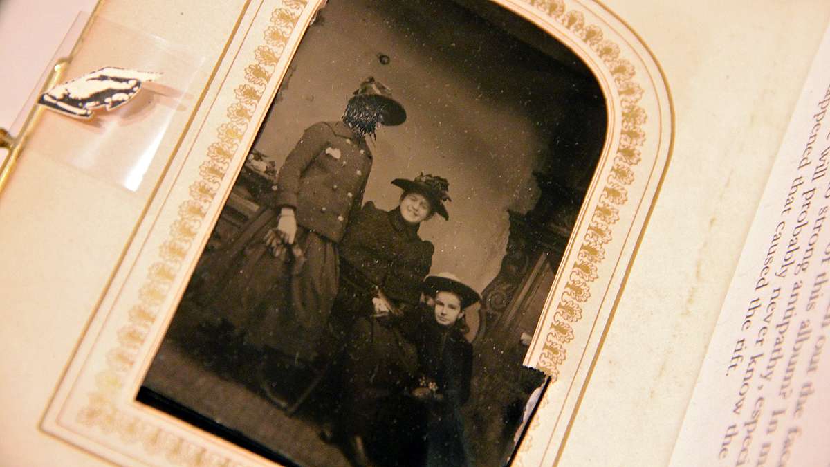 A woman's face is scratched out in a tintype from the 1890s, suggesting strong passions. (Emma Lee/for NewsWorks)