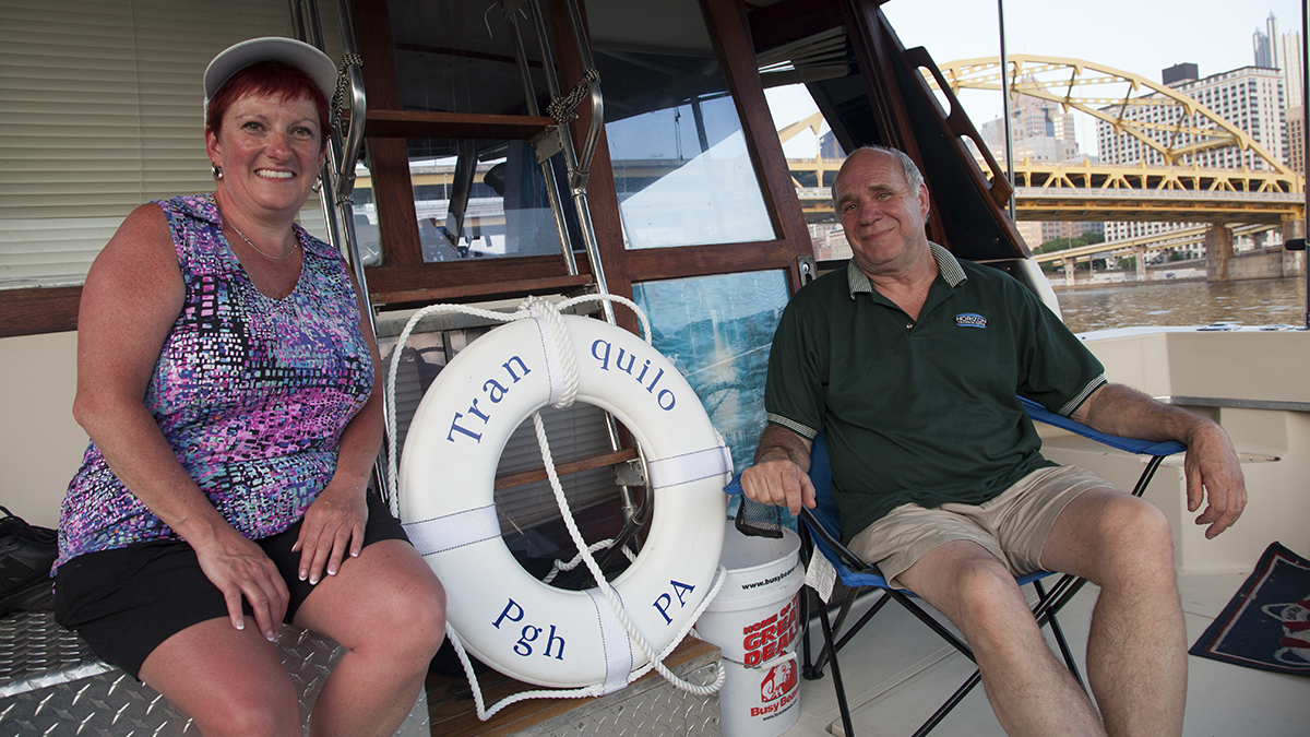  Dan Hennessy (right) and Jane McGrane boat, swim, and fish in Pittsburgh's rivers. Hennessy said he watched the waterfronts transform, starting with the Point, from industrial areas to more accessible public spaces. (Irina Zhorov/WESA)   