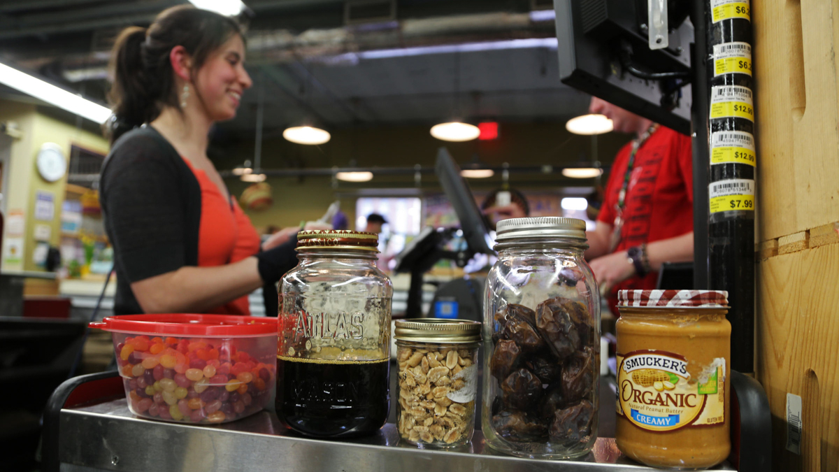  Mary Kate Ranii, 25, of Shaler, Pennsylvania,  shops at the East End Food Co-op, where she says cashiers are especially helpful for customers looking to make careful reductions in personal spending and waste. (Megan Harris/WESA) 