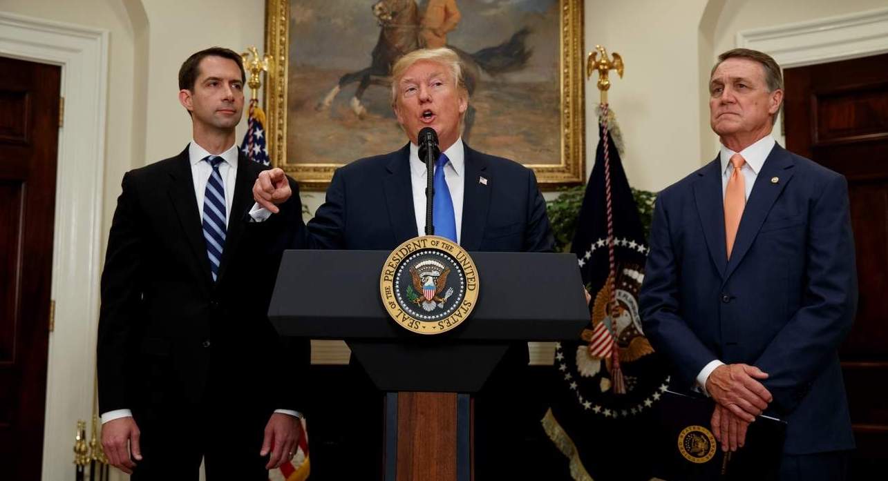  President Donald Trump, flanked by Sen. Tom Cotton, R- Ark., left, and Sen. David Perdue, R-Ga., speaks in the Roosevelt Room of the White House in Washington, Wednesday, Aug. 2, 2017, during the unveiling of legislation that would place new limits on legal immigration. (AP Photo/Evan Vucci) 