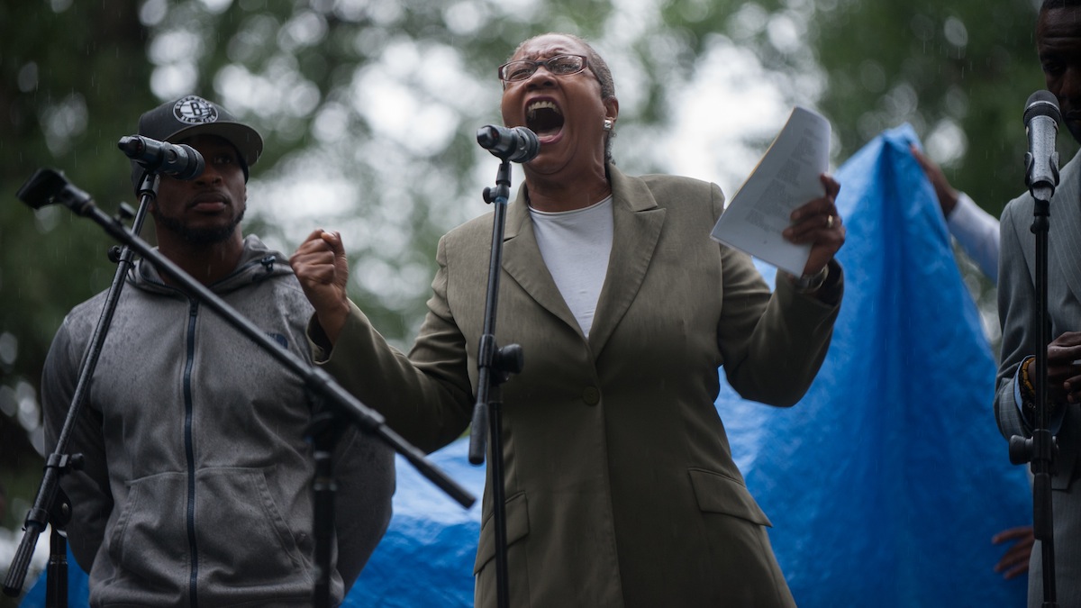 Lois Moses, of West Chester, reads her poetry aloud for the crowd during the People's Poetry and Jazz Festival in Germantown's Vernon Park Saturday afternoon.