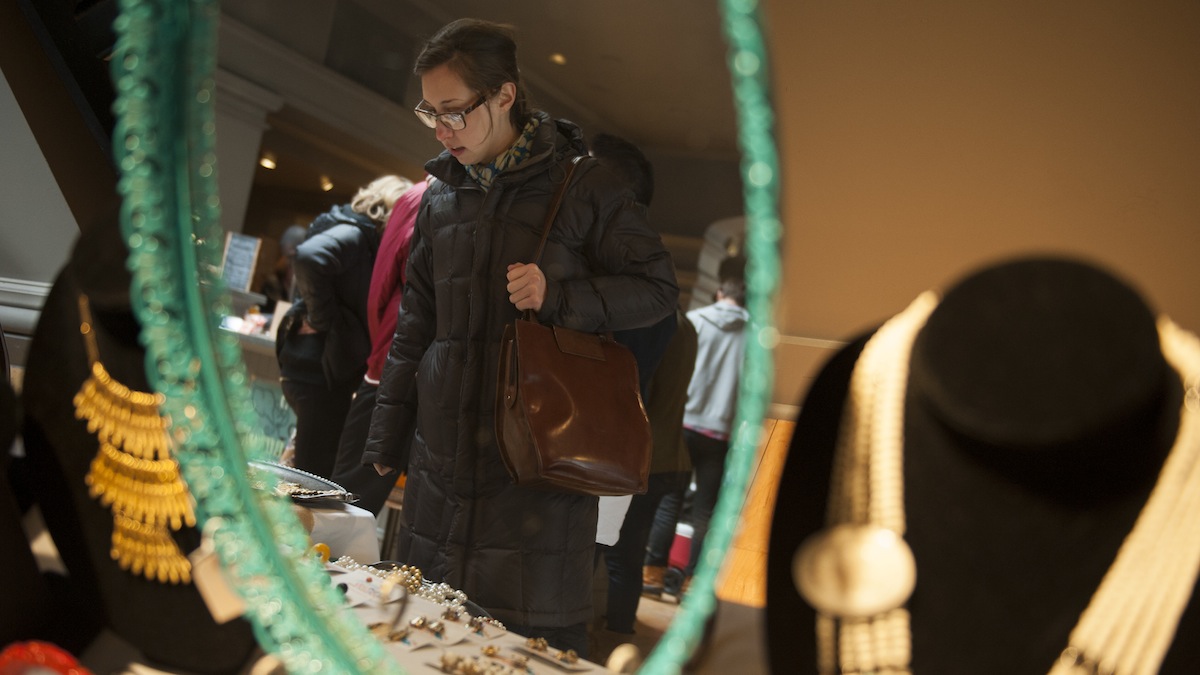 Laura Colussi, of Manayunk, looks at the vintage jewelry on display at the Philly Mart, a pop-up winter market, in Manayunk's Transfer Station.