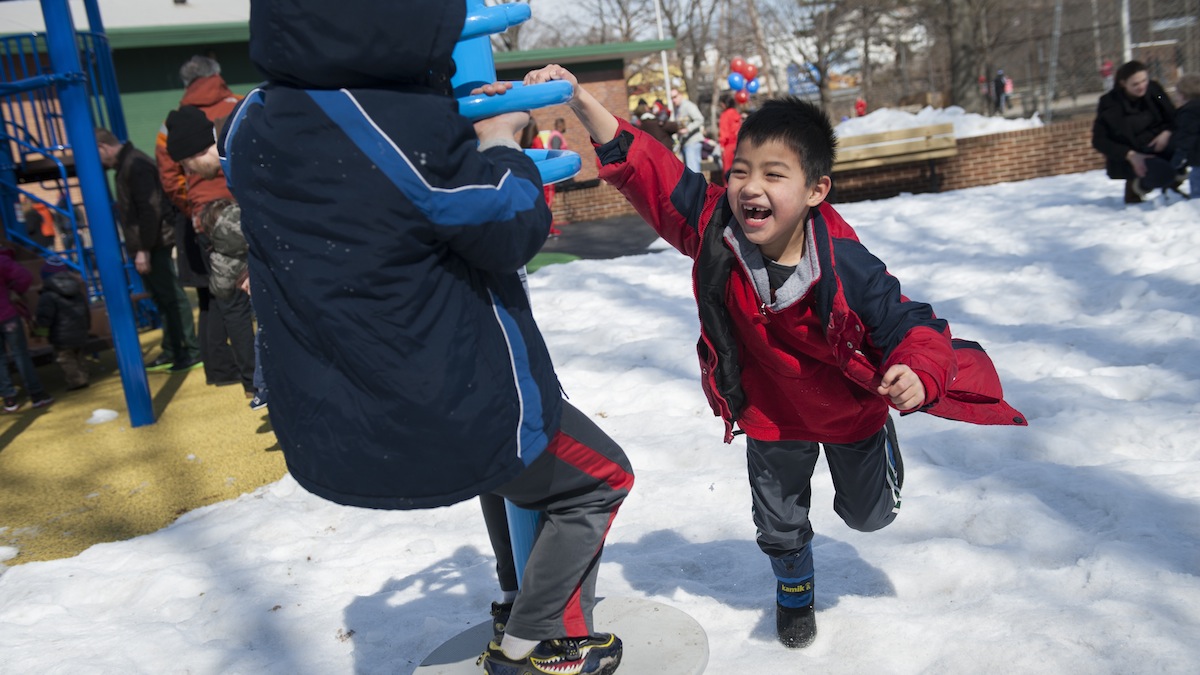 Arman Froggatt (right), 7, and Simon Labor, 7, both of Mt. Airy, play in the new jungle gym at McDevitt Recreation Center in East Falls on Saturday morning. Members of the community gathered to celebrate the playground's opening with food and games.