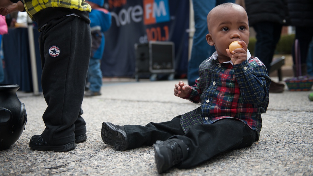 Xavier Motley, 1, of Kensington, tastes one of the eggs his brother collected during West Laurel Hill Cemetery's annual Easter egg hunt Saturday morning.