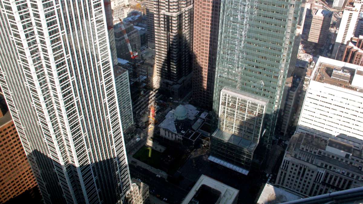 The shadow of One Liberty Place falls across the Arch Street Presbyterian Church, soon to be sandwiched between the city's two tallest buildings, both owned by Comcast.