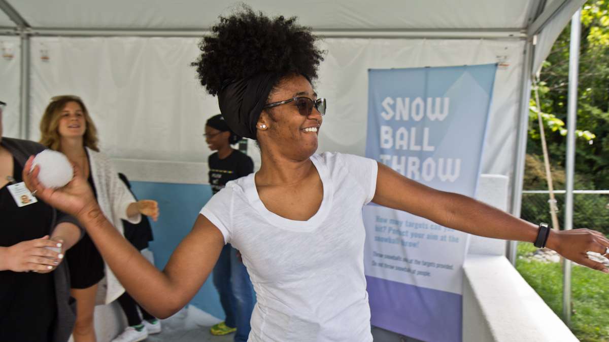 Janet Rhone throws a snowball at the target at the Winter exhibit.