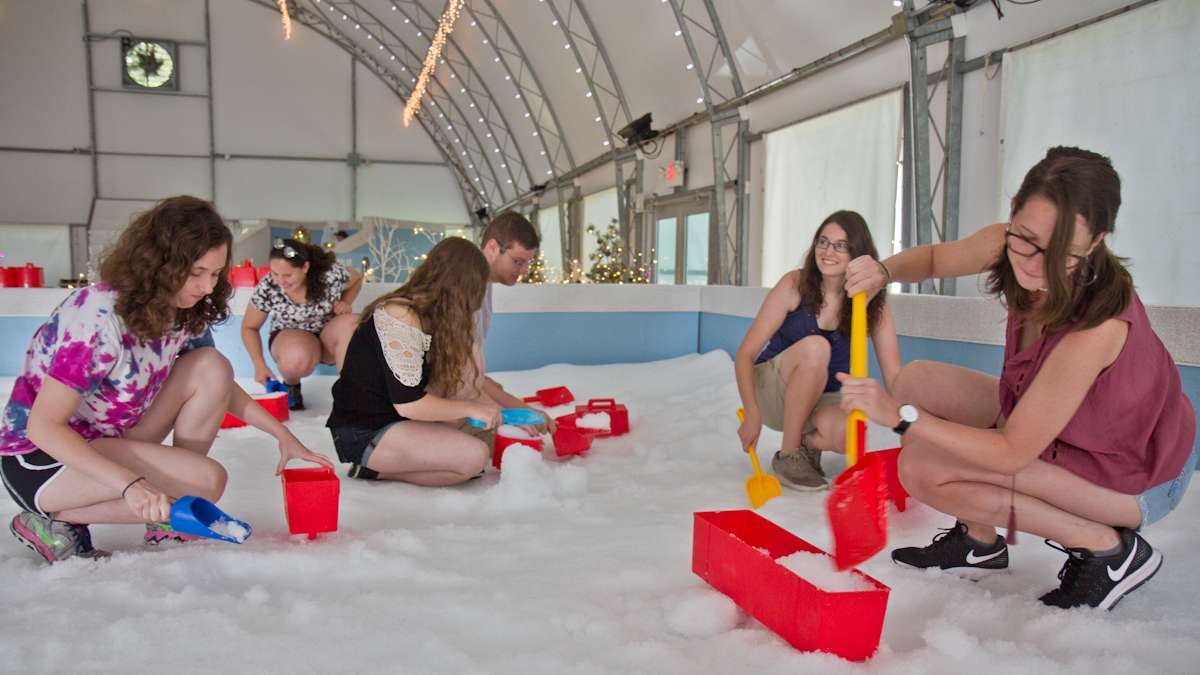 Visitors build an igloo at the Philadelphia Zoo Winter exhibit.