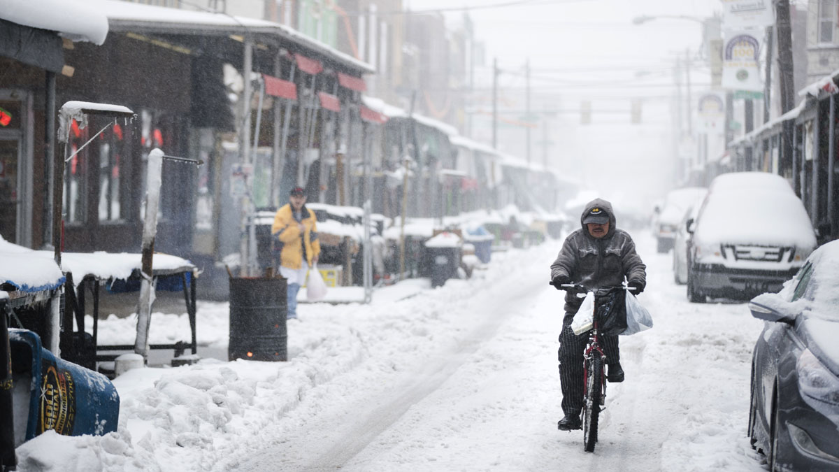  A man rides his bicycle during a winter storm in the Italian Market neighborhood of Philadelphia, Tuesday, March 14, 2017. (AP Photo/Matt Rourke) 